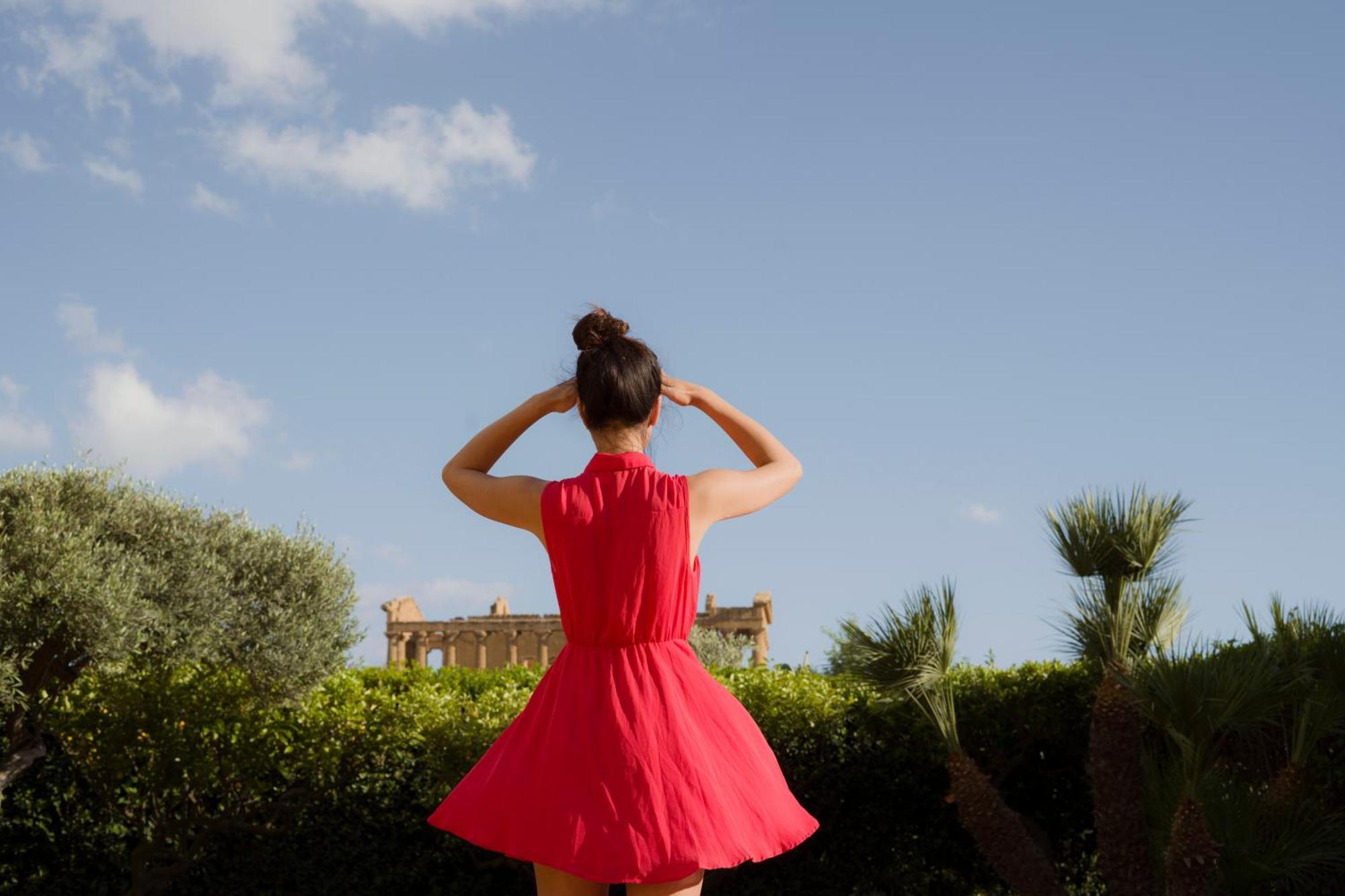 Villa Athena Resort Agrigento Zewnętrze zdjęcie A woman wearing a red dress